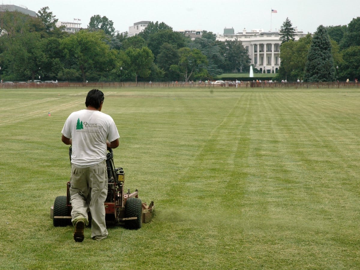 Grounds crew mowing a large commercial lawn
